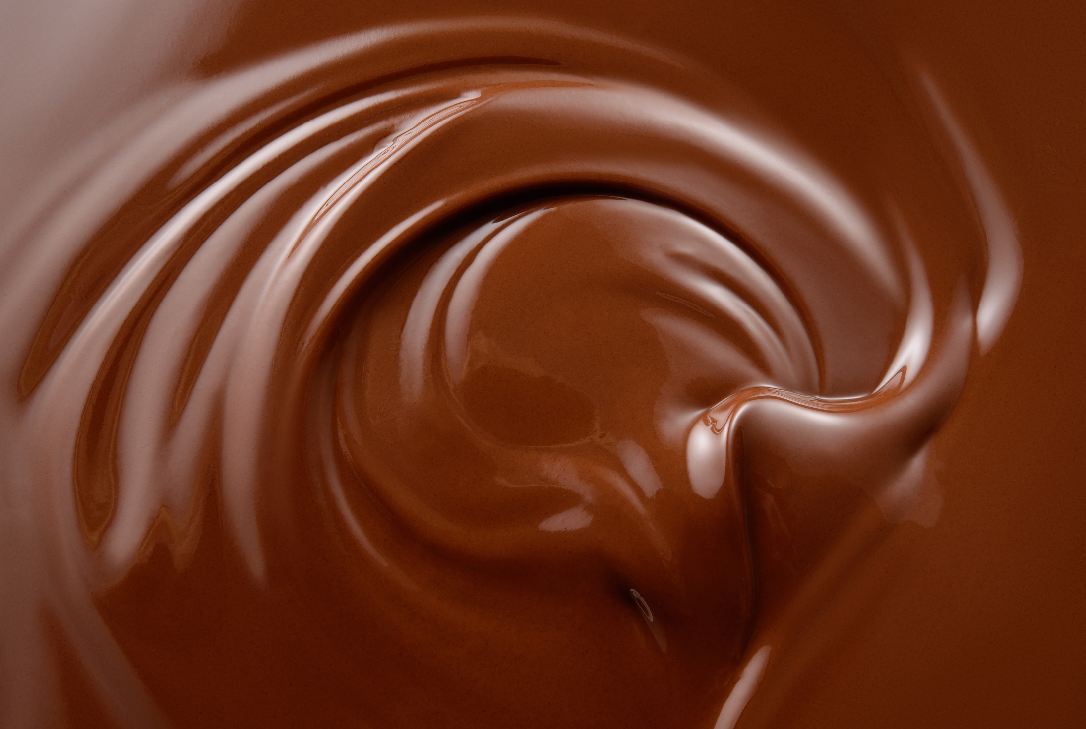 Chocolate background. Melted chocolate surface. Chocolate swirl.